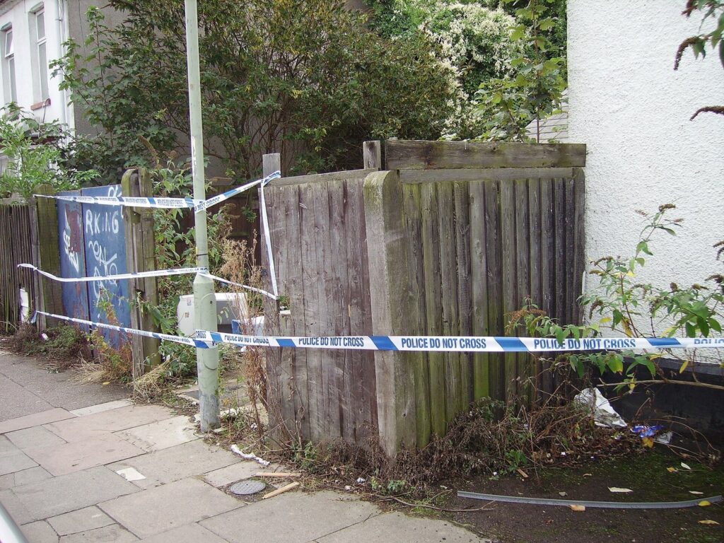 Police tape stretched across a scene